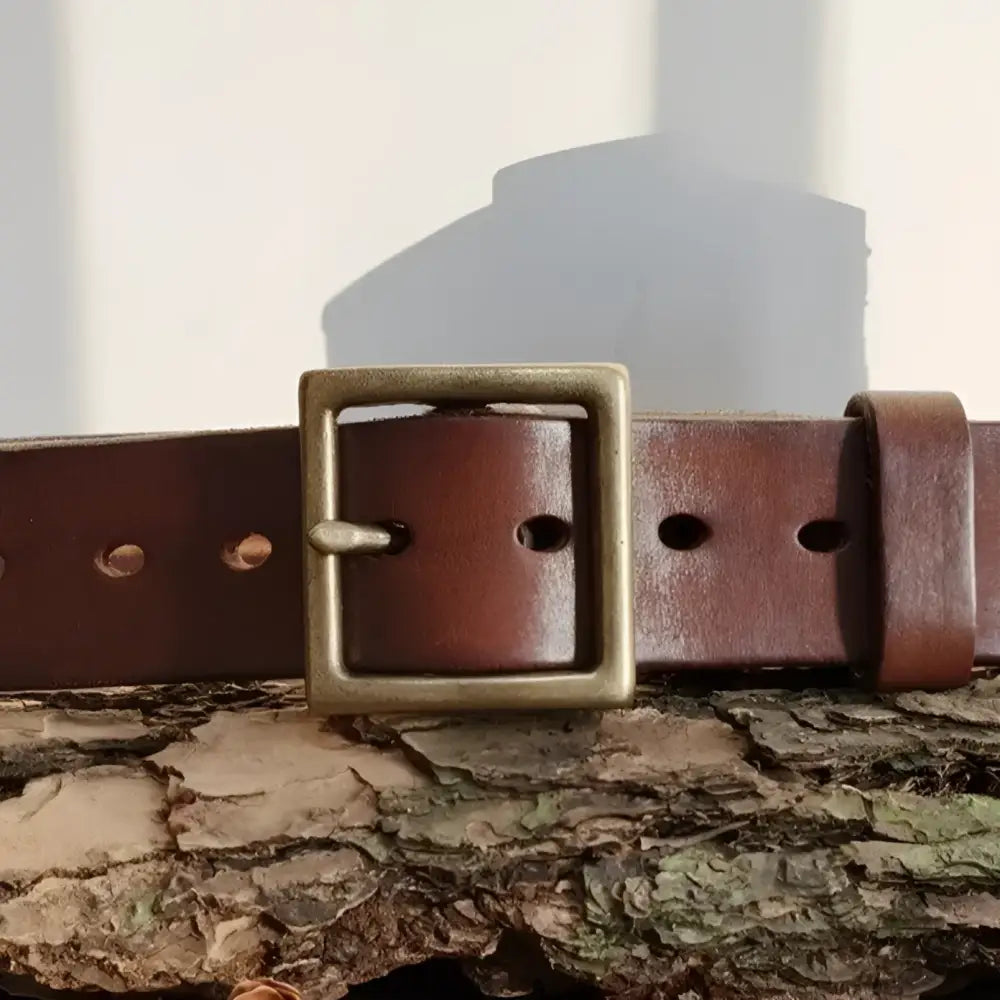 Set of two brown leather belts with brass buckles displayed for stylish men’s accessories