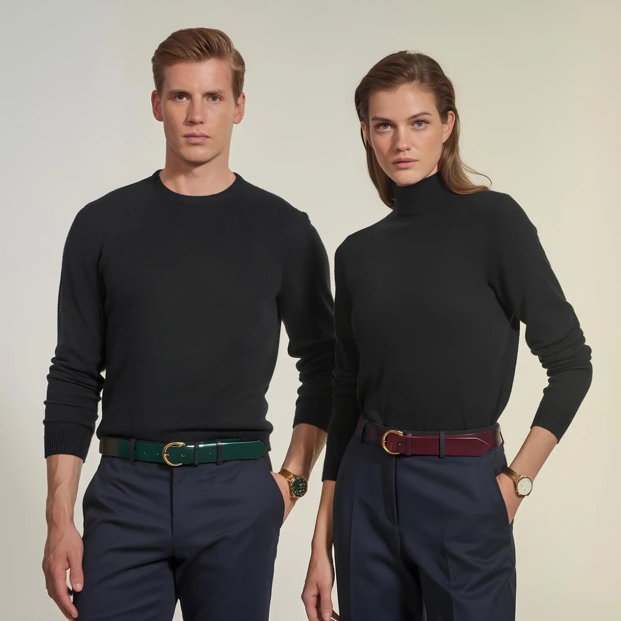 Two models wearing black sweaters and belts.