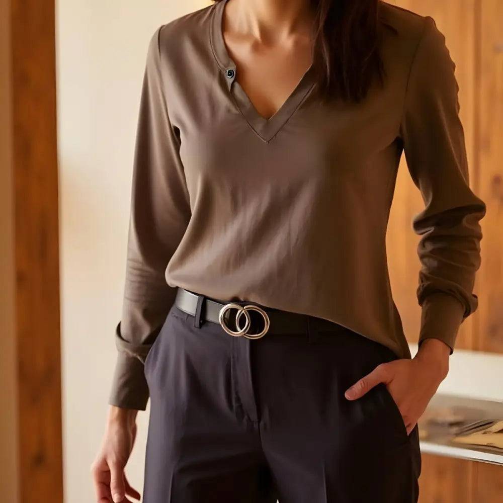 Woman wearing a stylish olive-green long-sleeved shirt with white pants