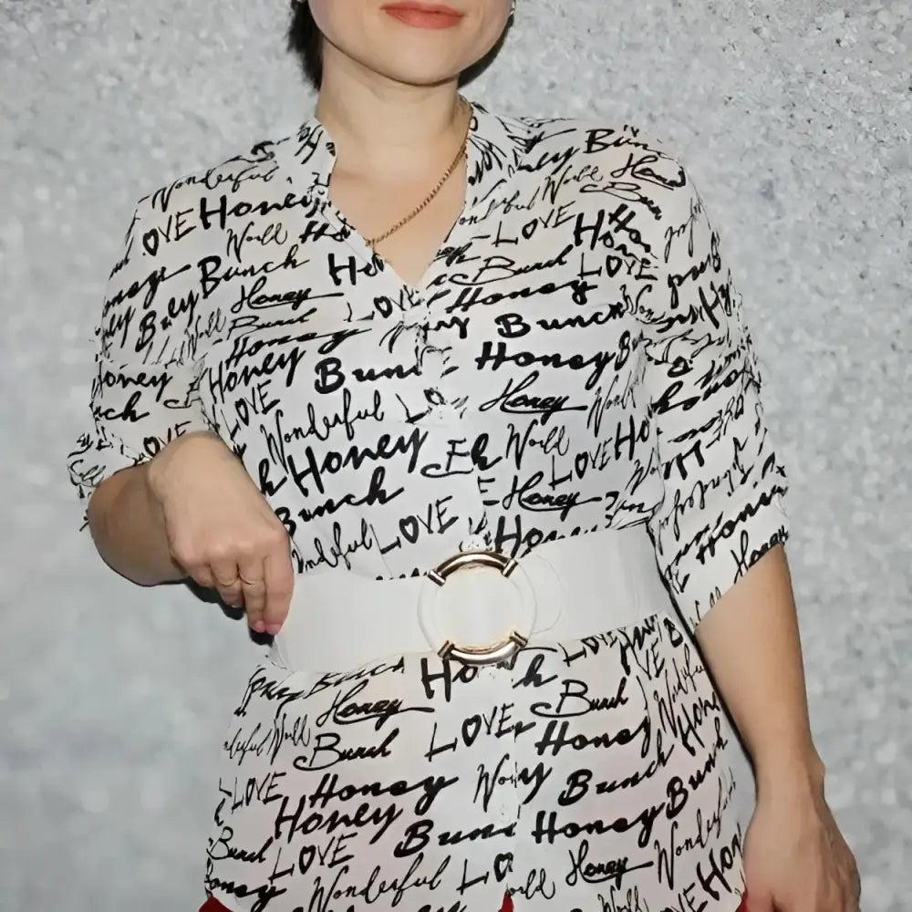 White blouse with black lettering and wide white belt from Black Elastic Belt with Gold Buckle collection