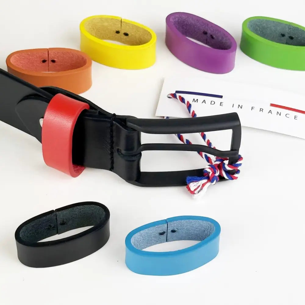 Black leather belt with red accent and colorful interchangeable loops and metal buckle