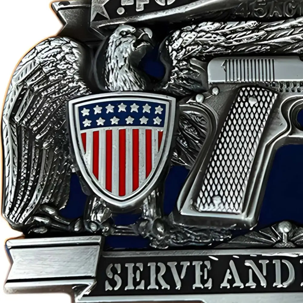 Silver eagle and pistol emblem on American belt buckle for durable style