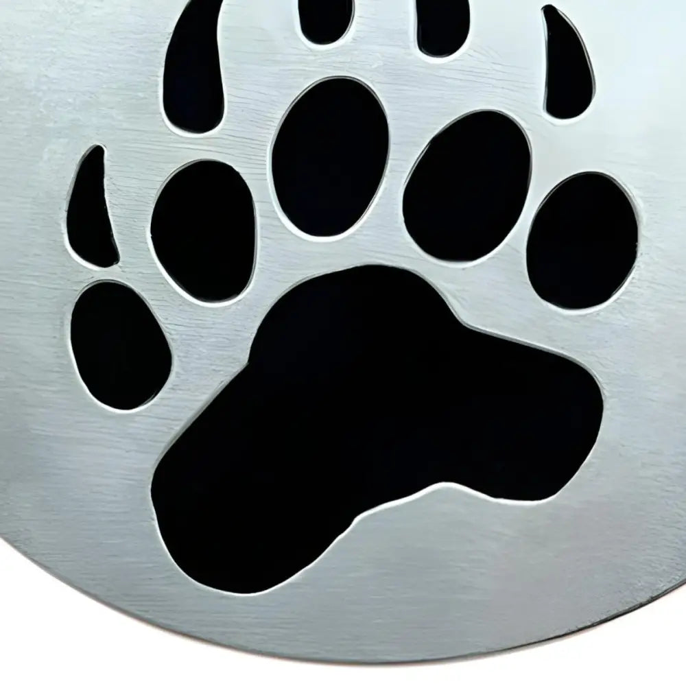 Metal bear paw cutout on Silver Drain Cover with paw print and bear paw design