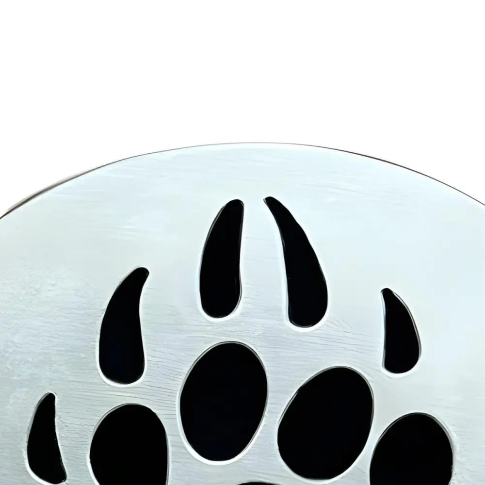 Silver drain cover featuring paw print and bear paw design, ideal as a unique belt buckle accessory