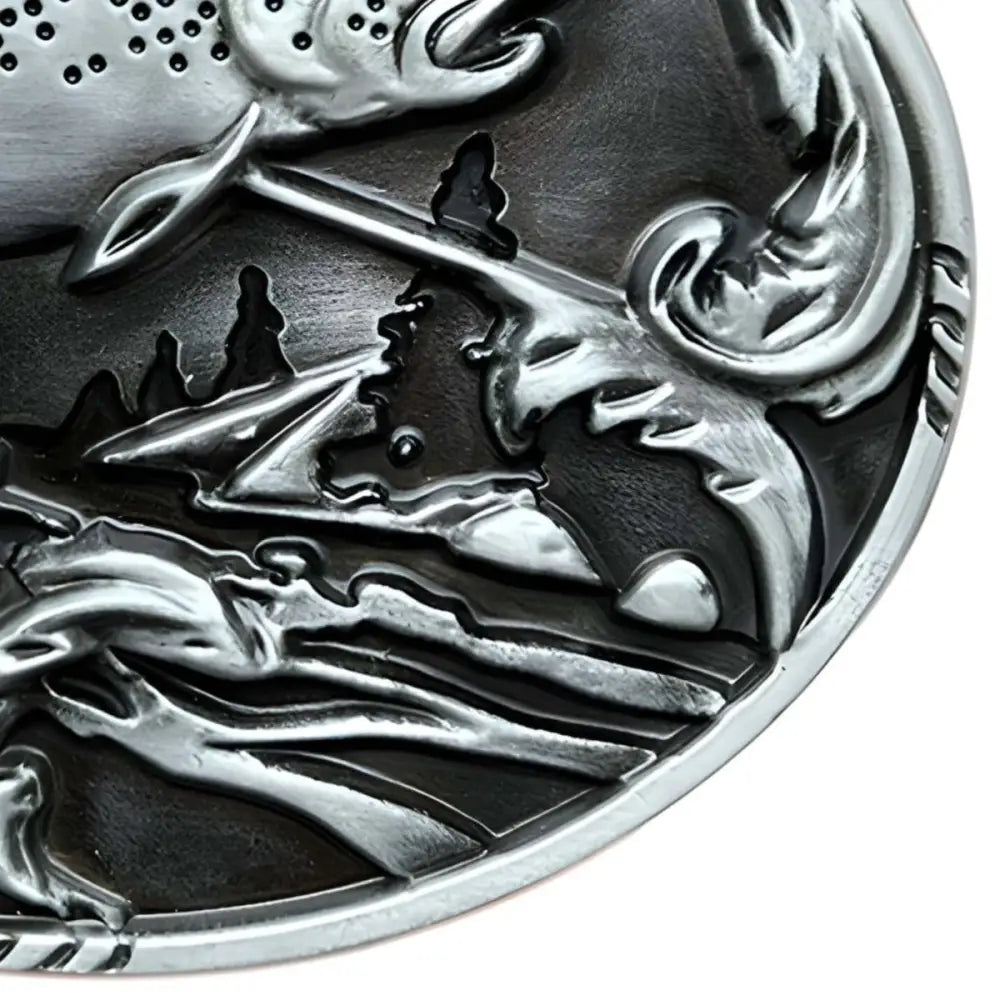 Silver-colored embossed metal disc belt buckle featuring a leaping trout design