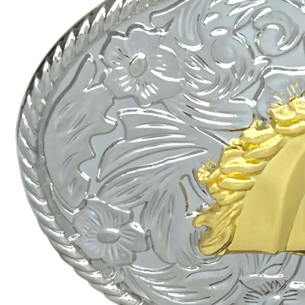 Ornate gold and silver belt buckle with horse head design and floral background