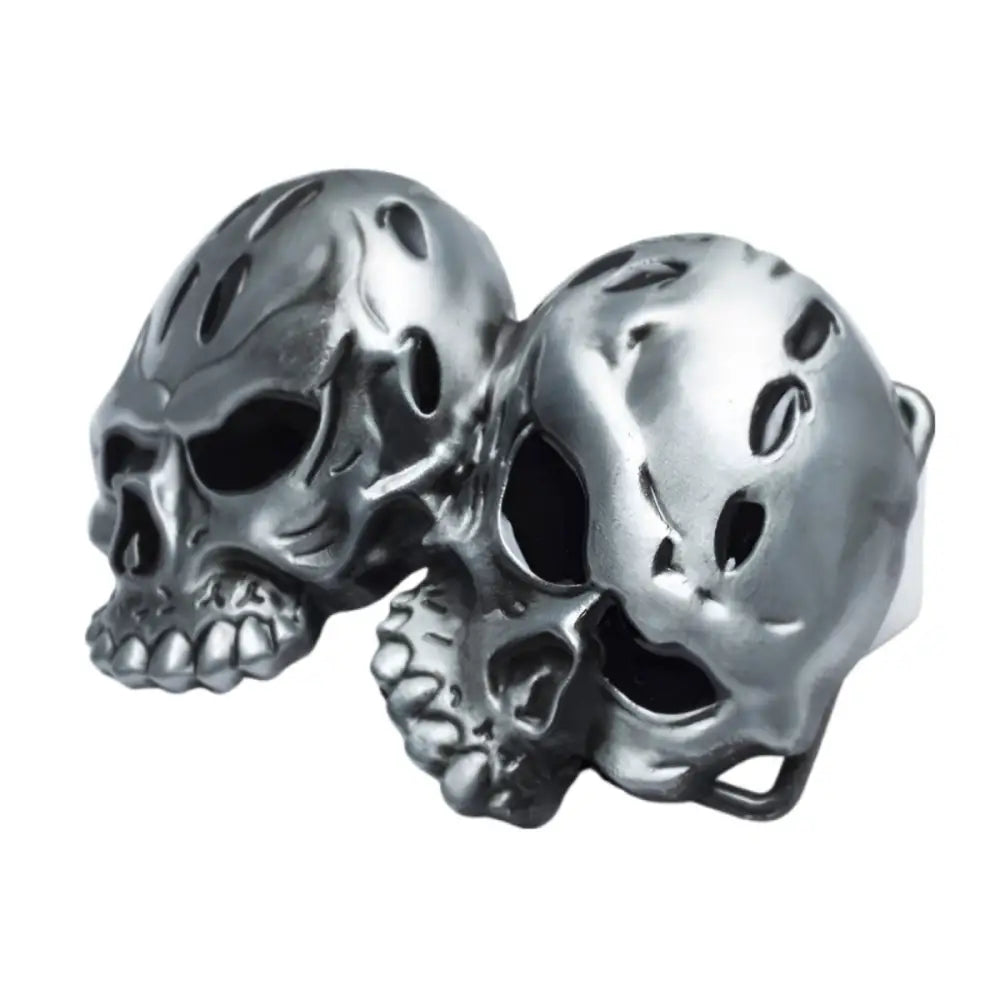 Silver skull rings displayed on Elvan Double Skull Belt Buckle featuring double skull design