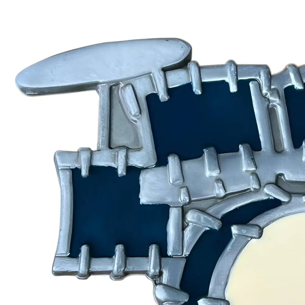 Stylized silver drum set pin featuring belt buckle for Ethan Drum Music and drum music belt