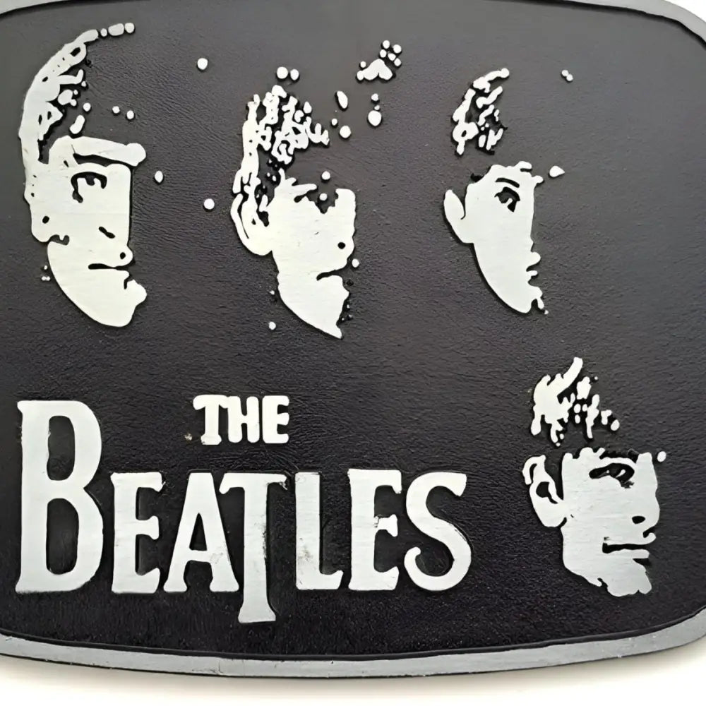 The Beatles belt buckle for fans of classic rock accessories featuring band logo design