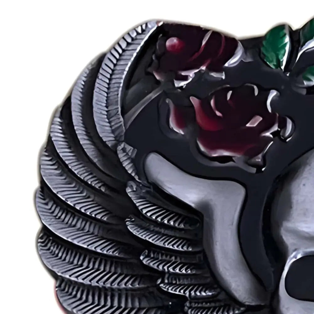 Gothic style silver belt buckle featuring a skull with roses and wings design