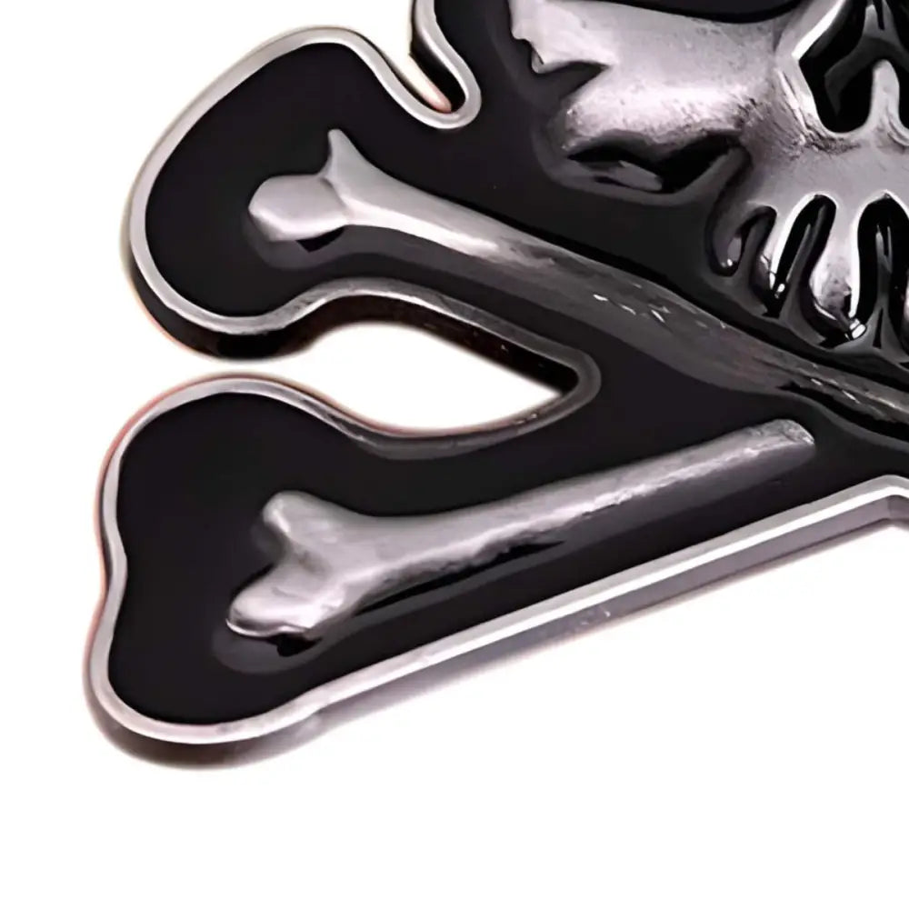 Chrome metallic skull and crossbones belt buckle with black and silver design