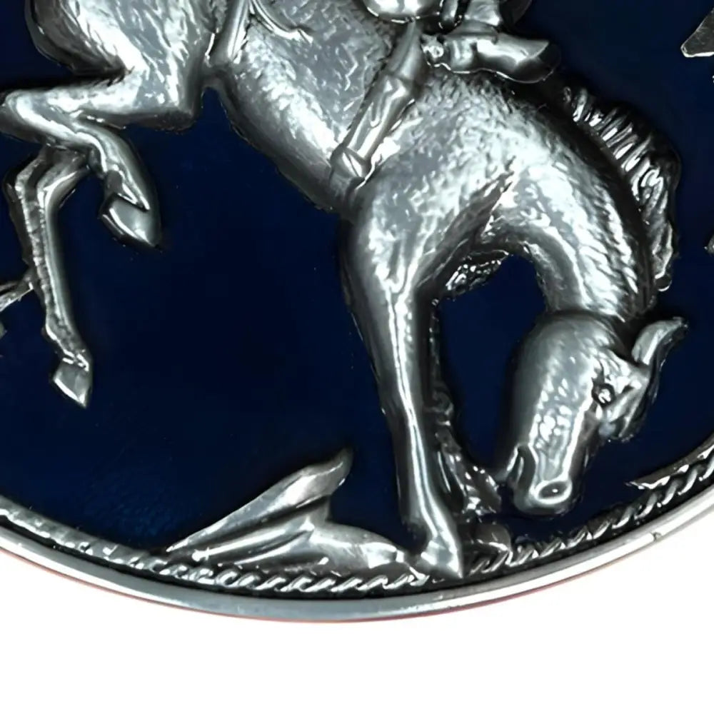 Silver horse and rider emblem on an oval belt buckle for a cowboy accessory