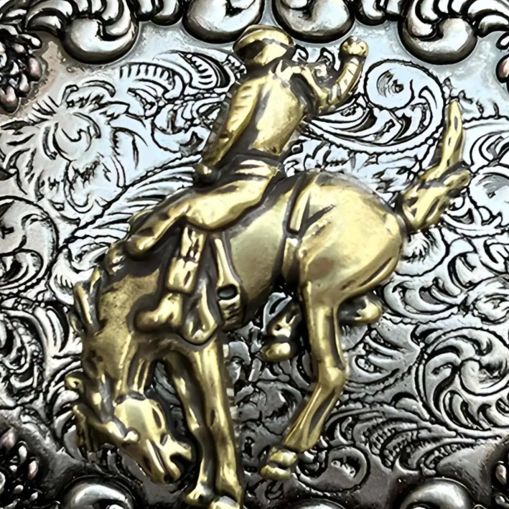 Ornate silver and gold belt buckle inspired by American West style