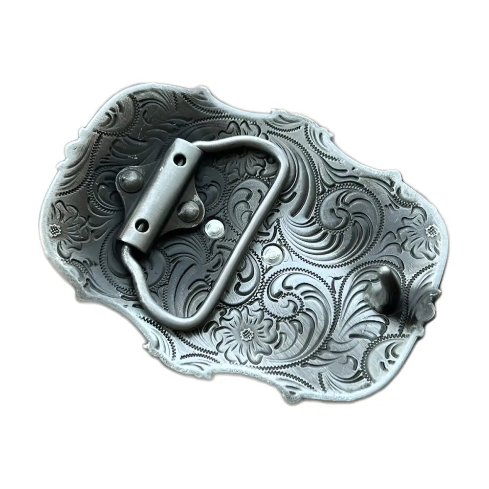Ornate silver and gold belt buckle featuring a bull skull design for western fashion