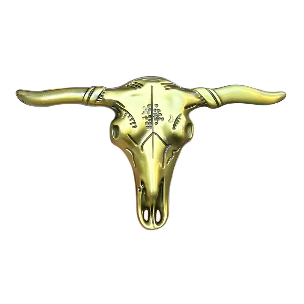 Golden and silver steer skull belt buckle with etched designs and long horns, Stanley model