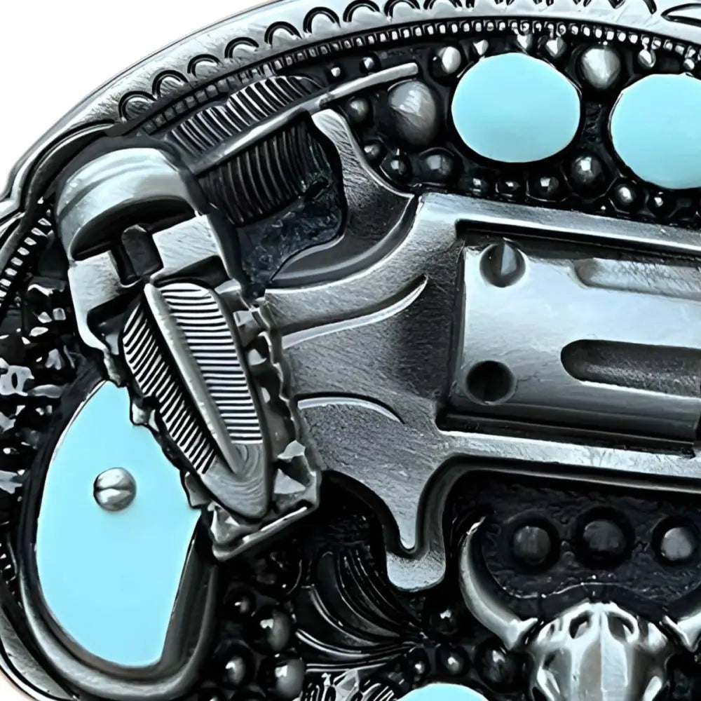 Silver gun belt buckle with turquoise accents showcasing a Western-style belt accessory
