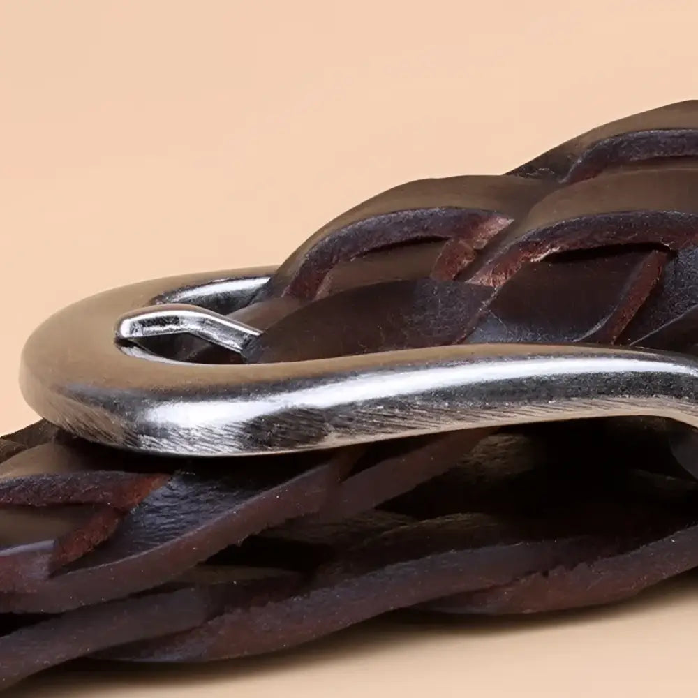 Braided brown leather belt featuring a silver buckle for stylish and durable wear