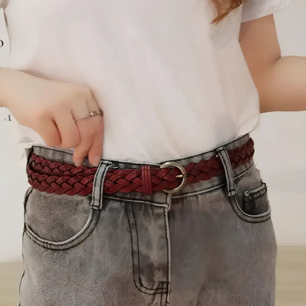 Braided burgundy leather belt displayed for denim shorts styling