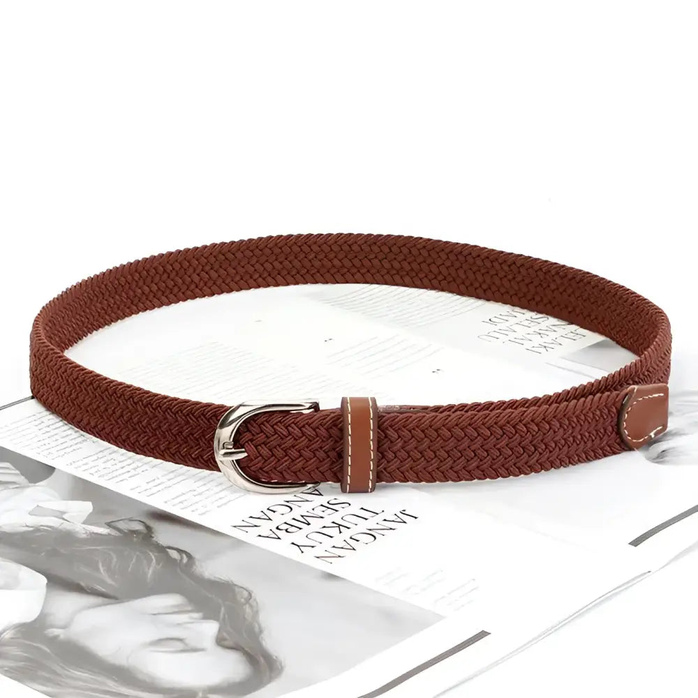 Braided elastic brown belt with leather accents and silver buckle for stylish wear