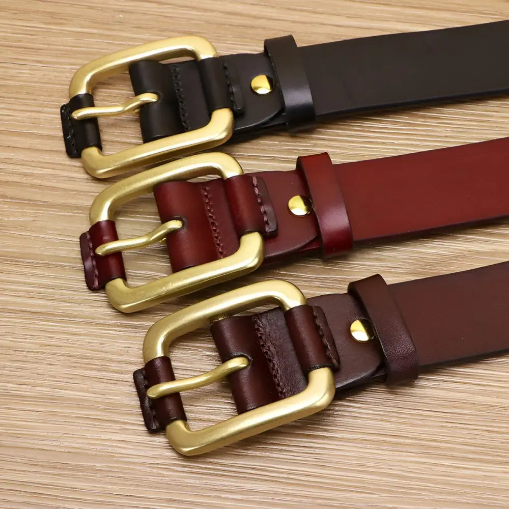 Three leather belts with brass and gold buckles displayed for the Brown Leather Belt product