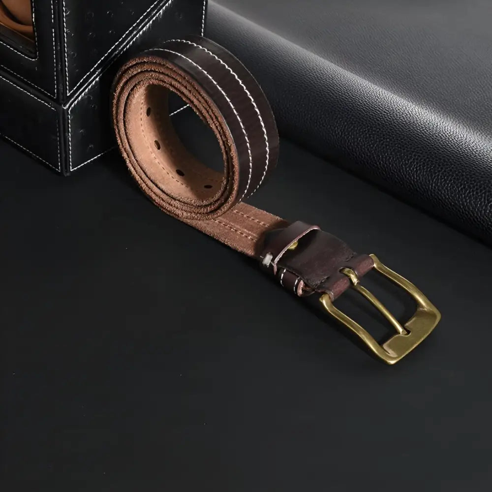 Brown leather belt with brass buckle displayed on a product page