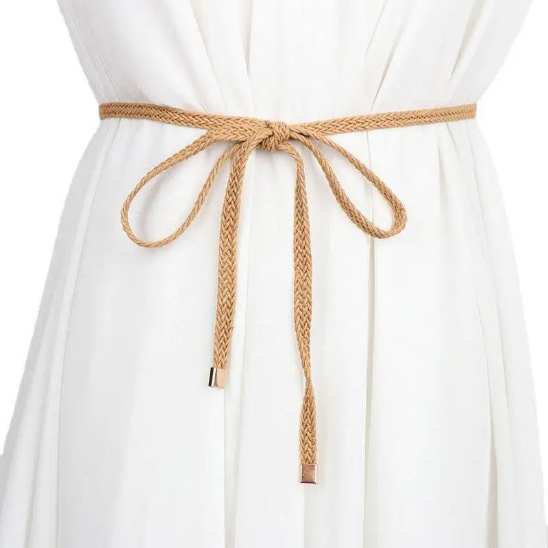 Braided tan belt tied in a bow around a white dress for a classic elegant look