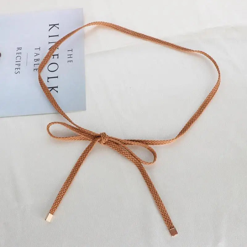 Braided brown belt tied in a bow for a classic look