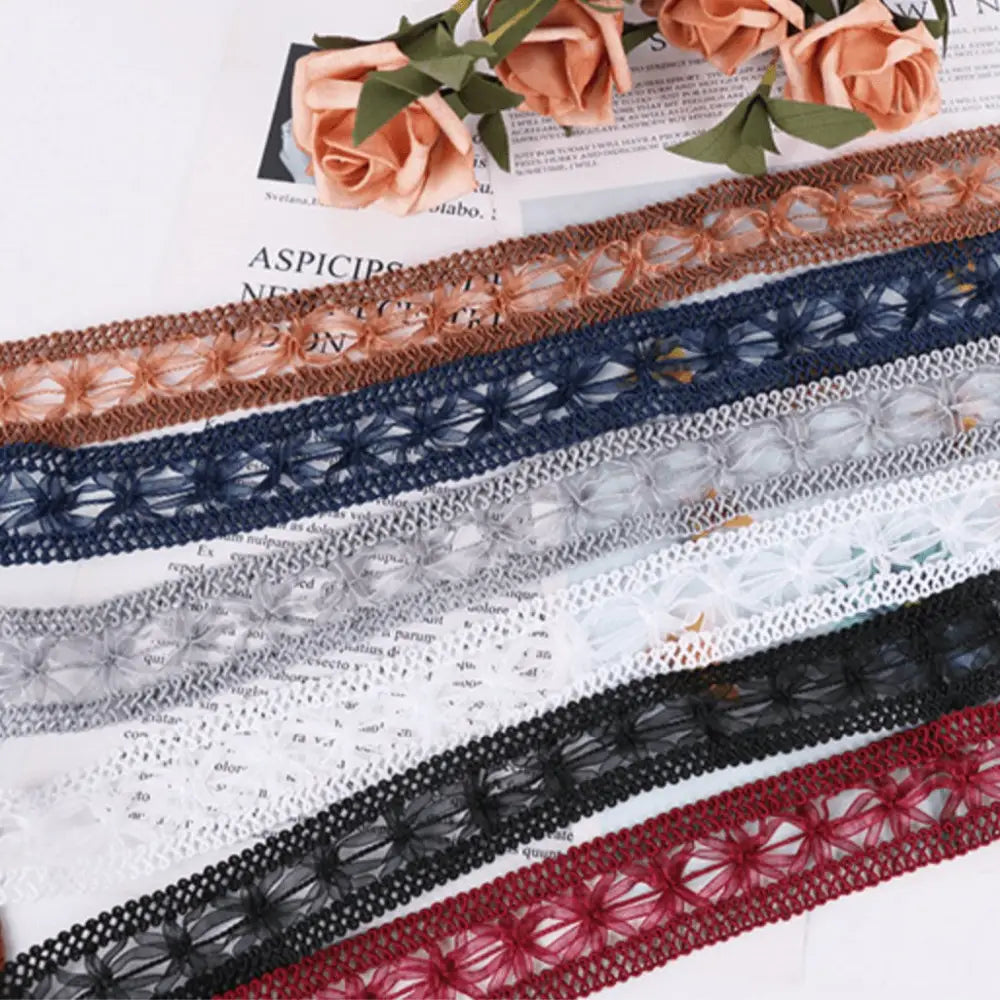 Colorful decorative lace trims on Janetta Lace Tie with decorative ribbon and braided cord