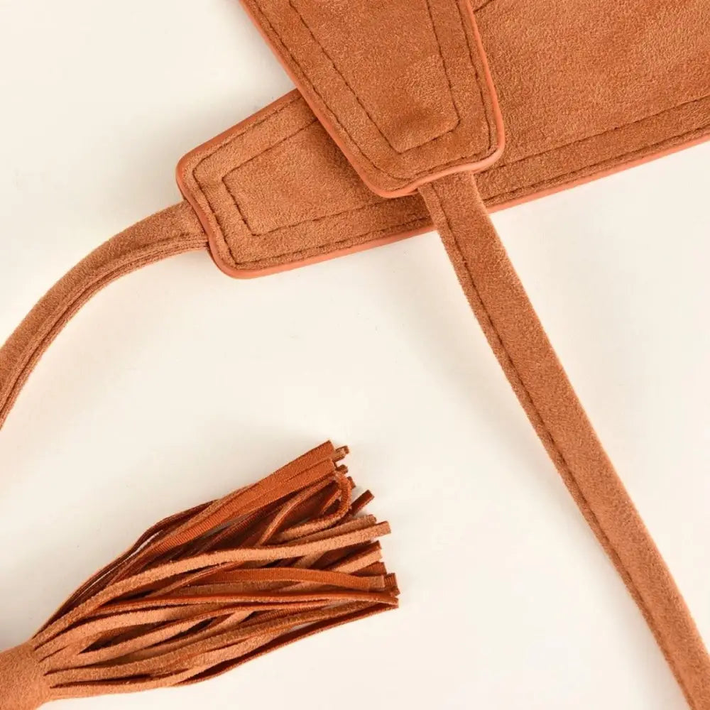 Brown suede belt with tassel accessory displayed with Floral Print Dress featuring Red Sash