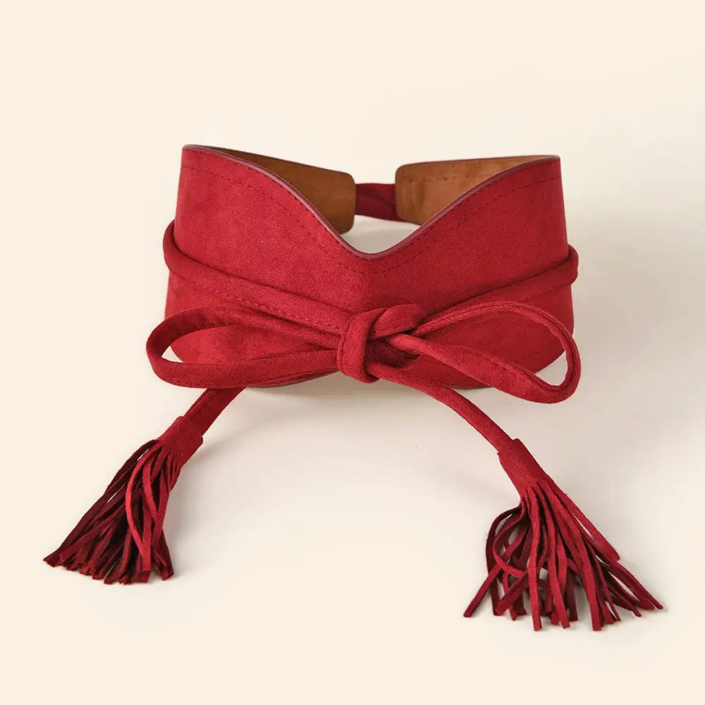 Red suede obi belt with tassels displayed with Floral Print Dress with Red Sash and Tassel Belt