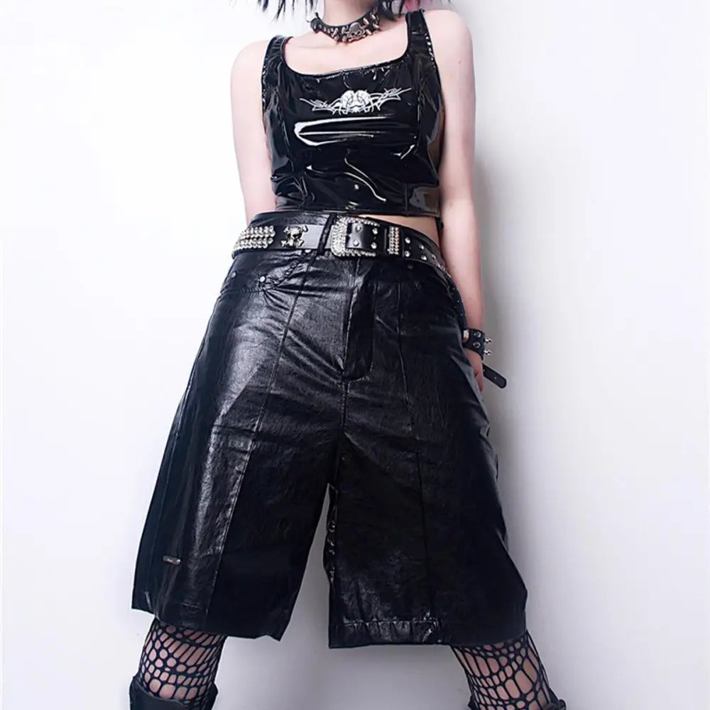 Shiny black vinyl culottes and top with Zephyr rhinestone belt and skull detail