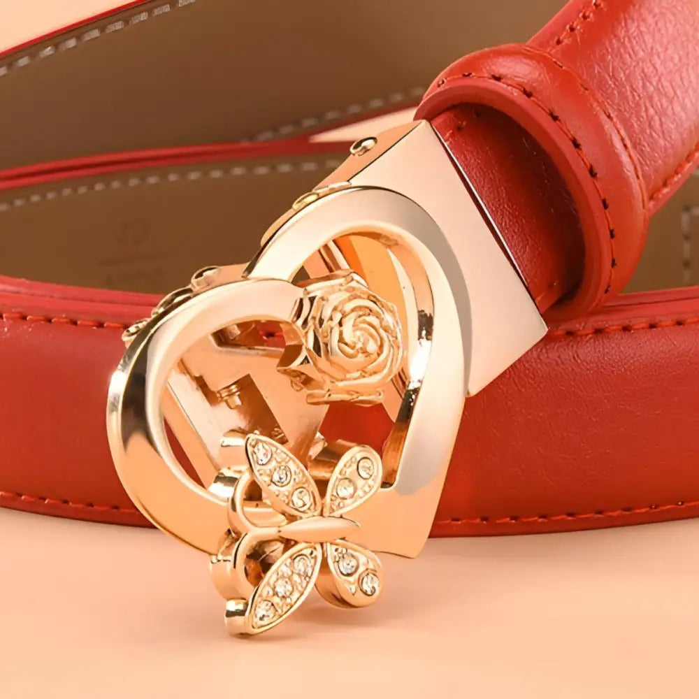 Red leather belt with heart-shaped and gold buckle details for stylish accessories