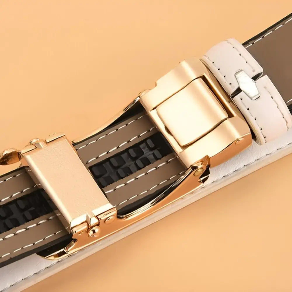 White and brown leather belts with gold buckles and jewel embellishments for stylish accessorizing