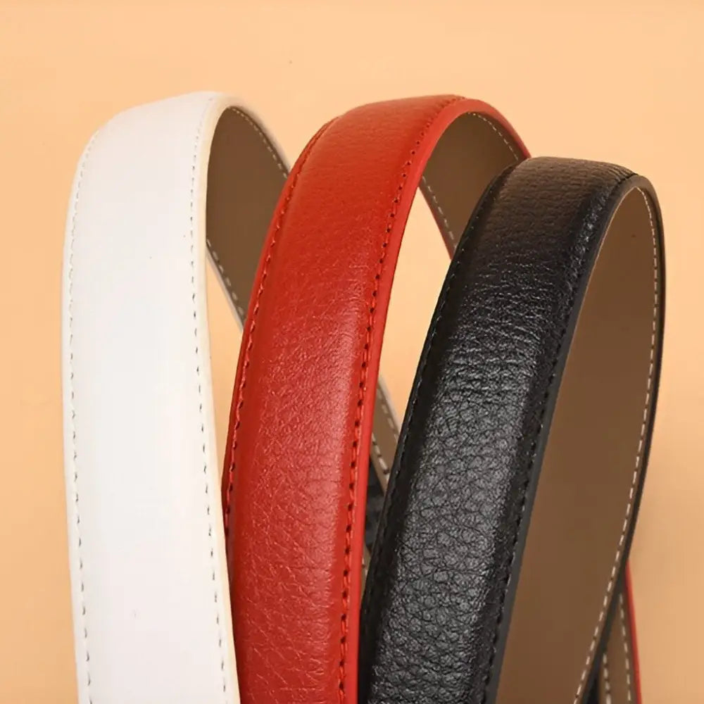 Set of three leather belts in white, red, and black with jewel-embellished gold buckles
