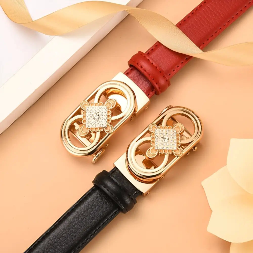 Red and black leather belts with gold jeweled buckles for stylish fashion accessories