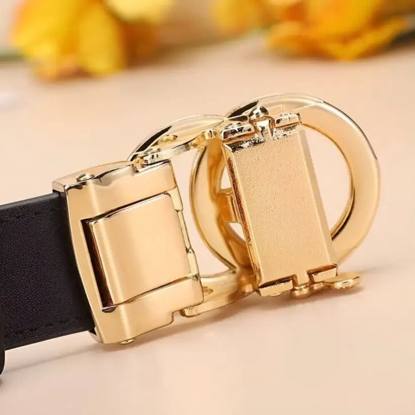 Gold-toned belt buckle on automatic leather belt with heart-shaped buckle for stylish look