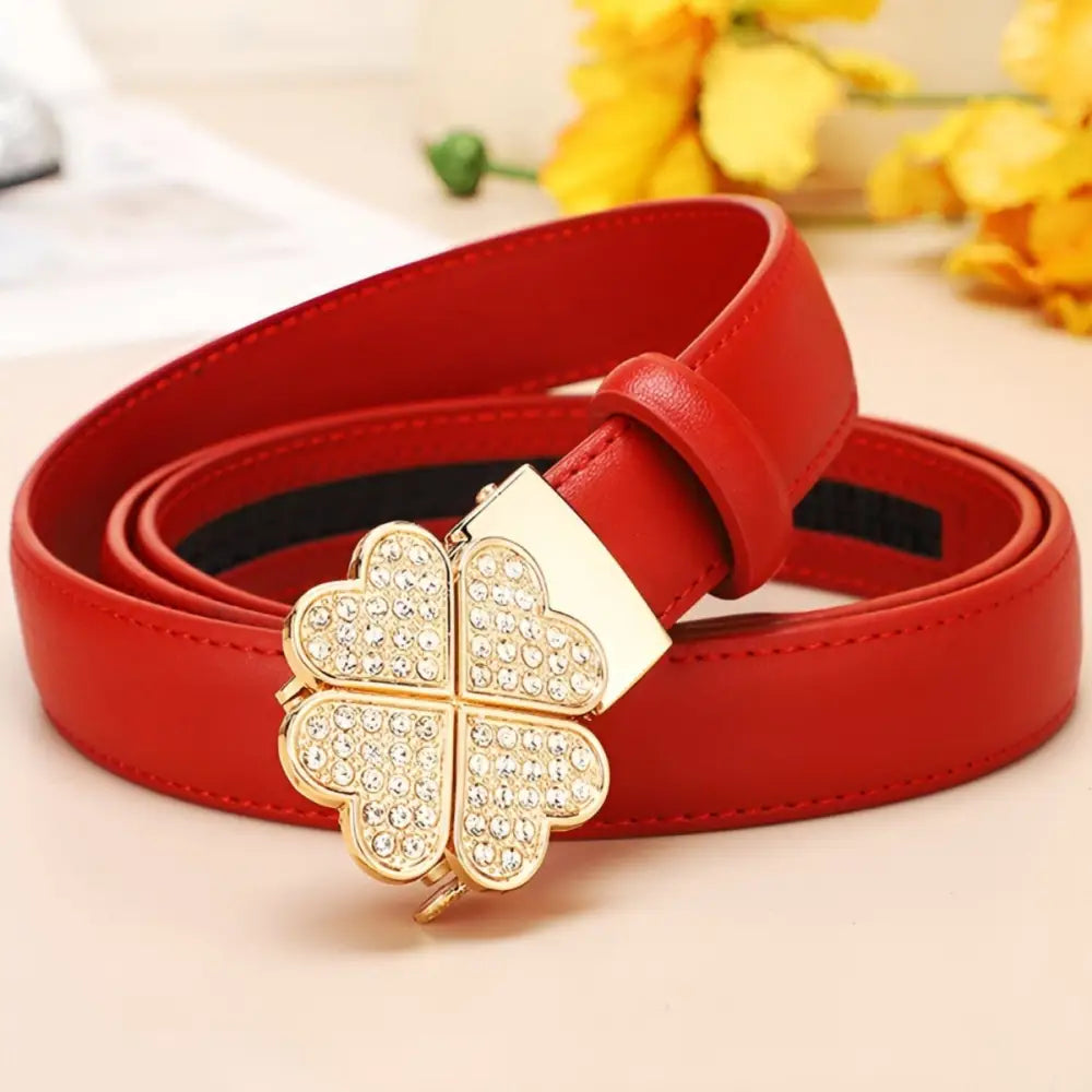 Red belt with clover-shaped rhinestone buckle from Selina Leather Belt collection