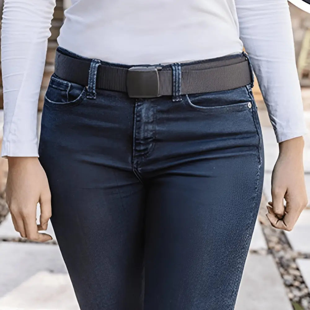 Dark gray metal-free money belt with hidden pocket on blue jeans featuring black buckle