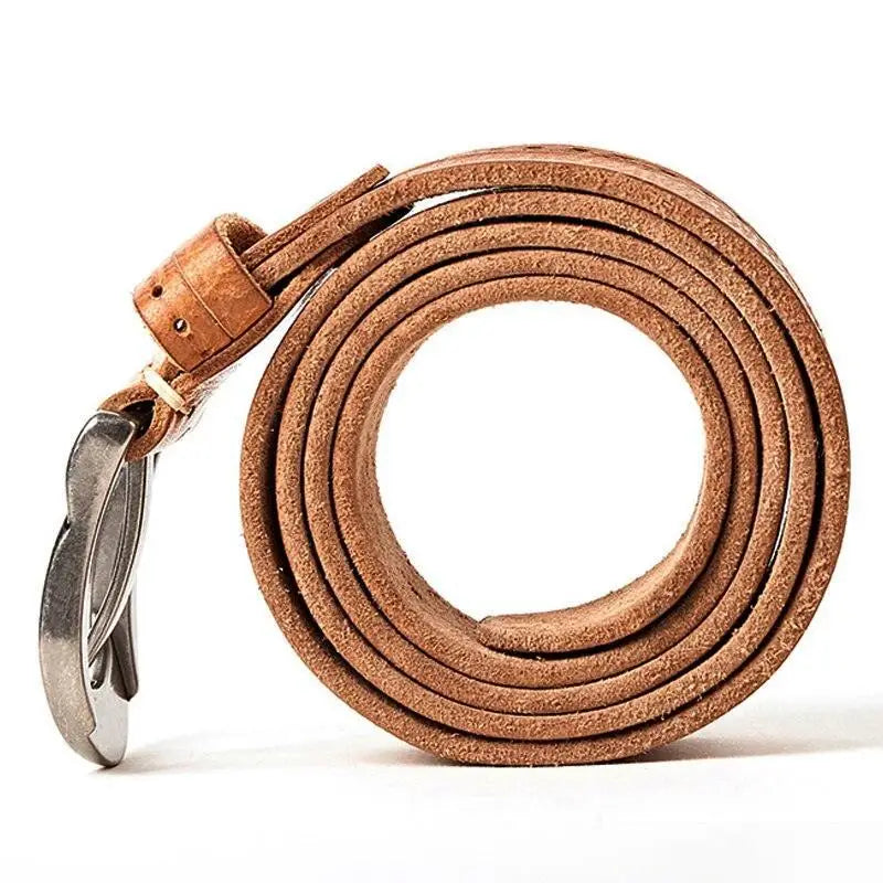 Coiled brown leather belt with silver buckle displayed with ripped blue jeans