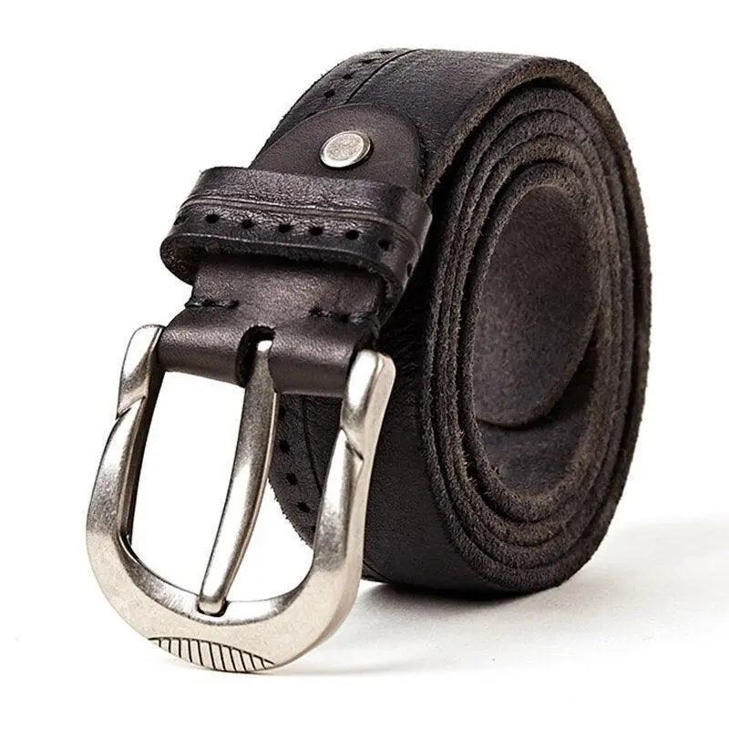 Rolled black leather belt with a silver buckle displayed with Ripped Blue Jeans