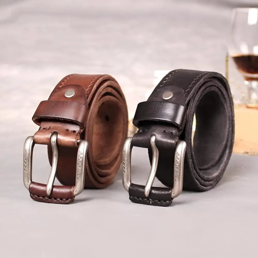 Two brown leather belts with silver buckles displayed for men’s fashion