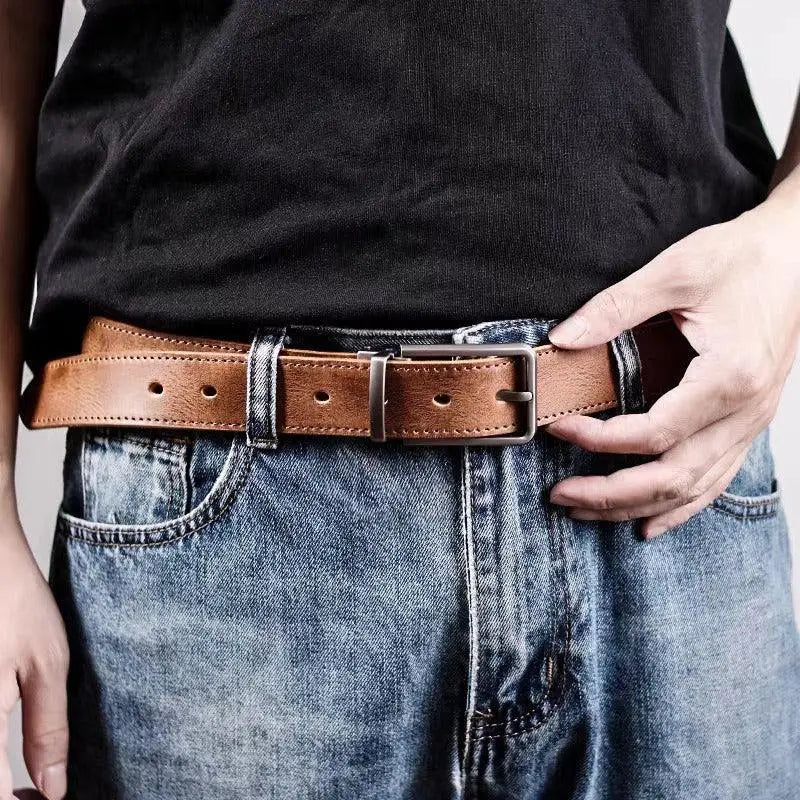 Set of three leather belts with silver buckles for men and women stylishly displayed