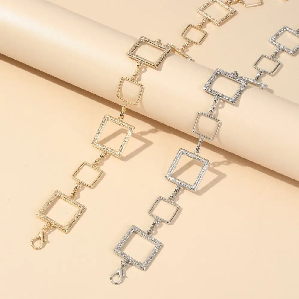 Two square-linked metal chain belts featured in Black Mini Skirt with Silver Chain Belt product