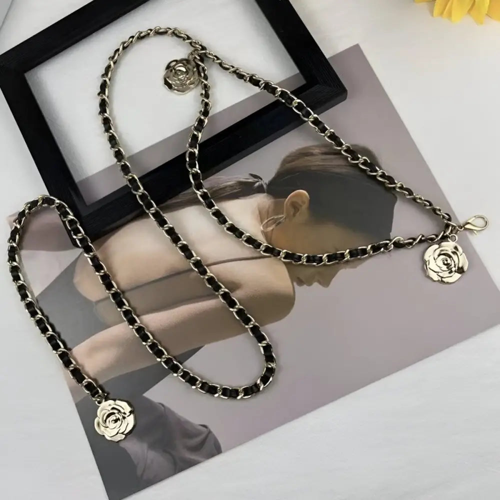 Gold chain belt with rose-shaped charms for elegant black dress accessorizing