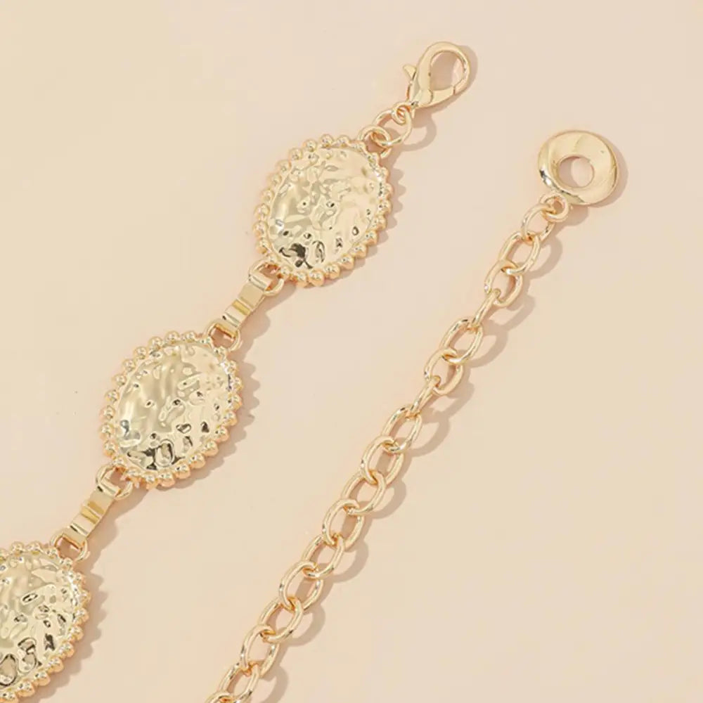 Gold-toned coudathoe chain belt with coin design showcasing elegant chain belt fashion