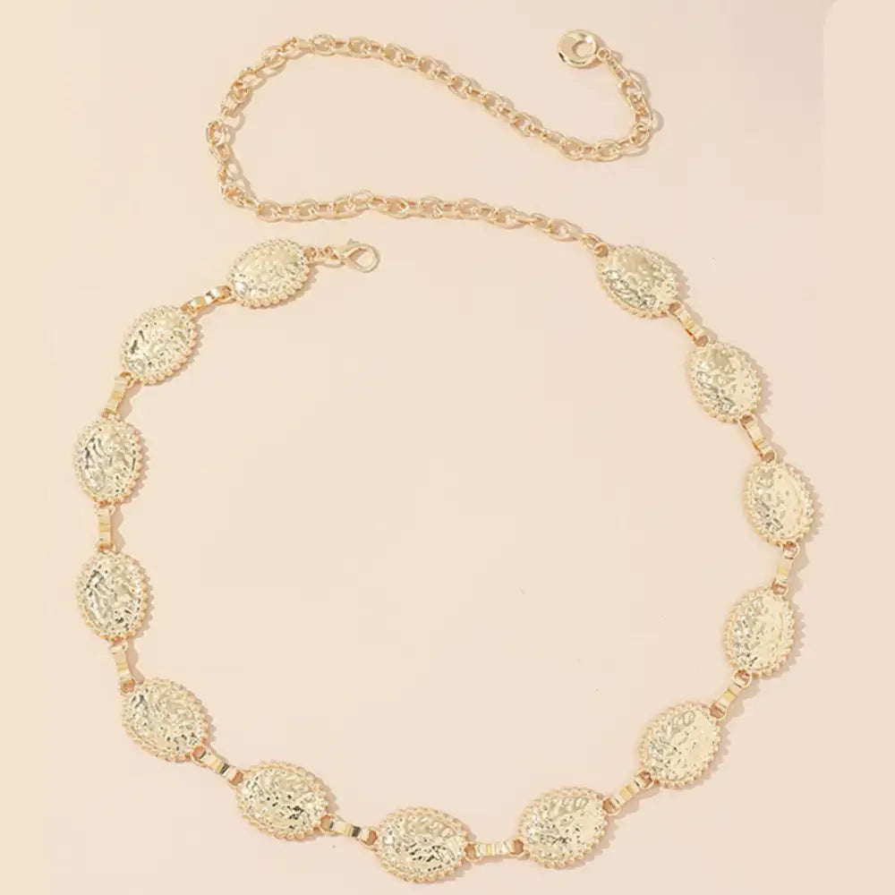 Gold-colored oval-linked coudathoe chain belt with coin design for elegant fashion accessory