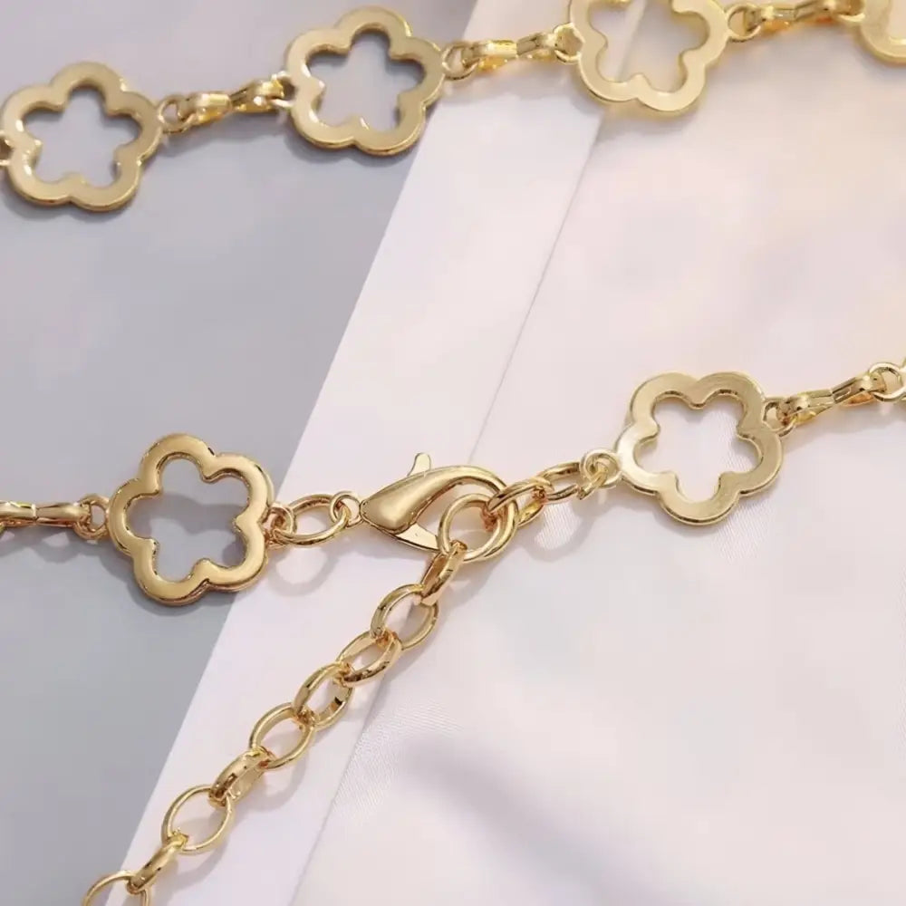 Gold-toned floral chain necklace accessory paired with Light Blue High-Waisted Jeans