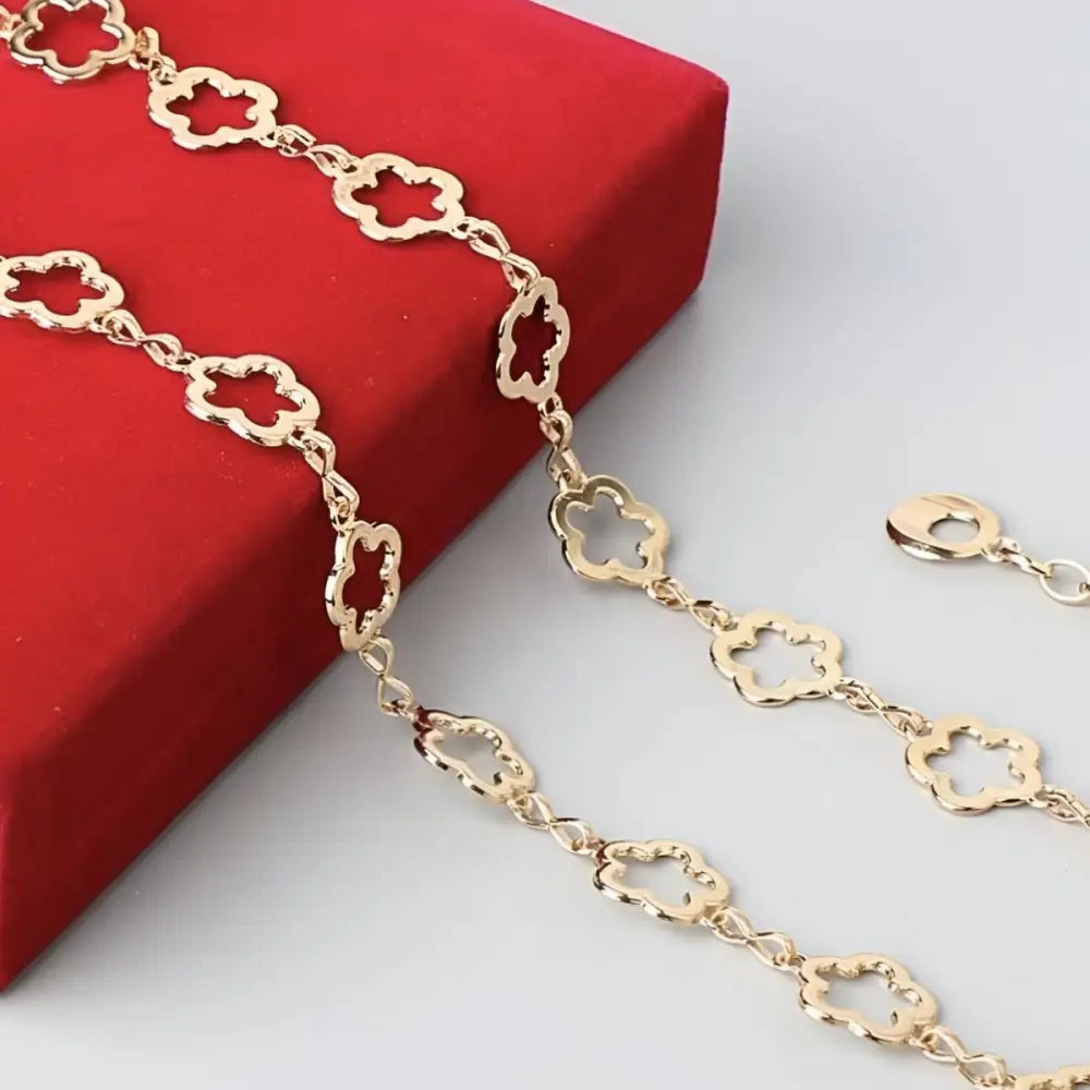 Gold-toned clover-shaped chain accessory featured with Light Blue High-Waisted Jeans