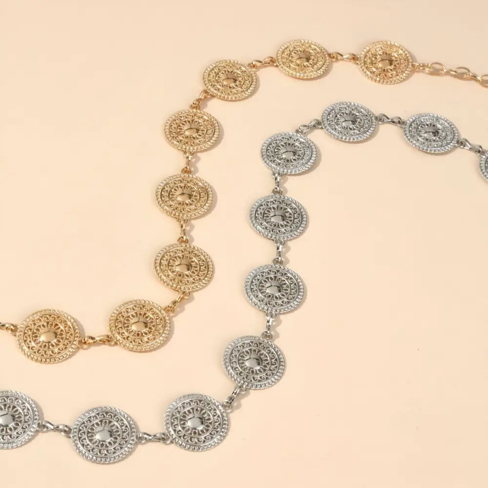 Silver Orya chain belt with circular medallions enhances aesthetic appeal for black mini skirts