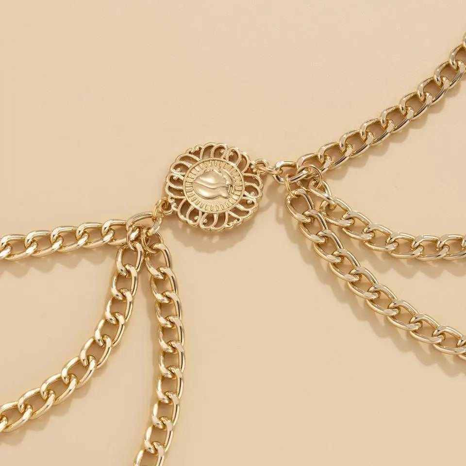 Gold-toned royliope belt chain adorns elegant green satin dress accessory